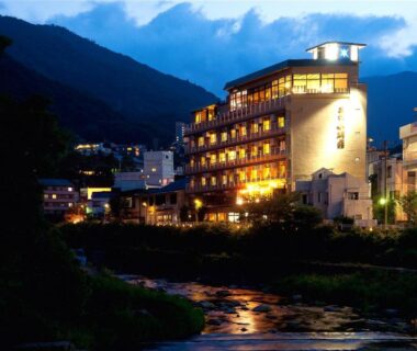 Illuminated riverside building beside a flowing river, Hakone Suimeisou, Kanagawa, Japan