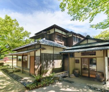 Traditional wooden ryokan exterior with shoji screens and tiled roof at Hakone Suishoen in Kanagawa, Japan