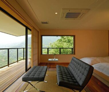 Tatami floor, low chairs and beds opening to balcony with green mountain view at Hakone Tokinoshizuku, Kanagawa