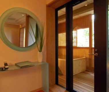 Interior with tatami seating and glass doors opening to a wooden bath at Hakone Tokinoshizuku, Kanagawa