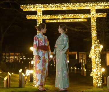 Two people in kimono at illuminated torii near Hakone Yunohana Prince Hotel in Kanagawa