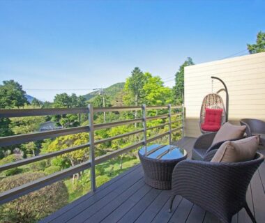Wicker seating and hanging chair on a ryokan balcony at Hakone Yuyado Zen in Kanagawa