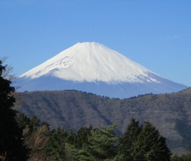 Snow-capped Mount Fuji rising above forested hills near Hakone, Kanagawa, Kanto