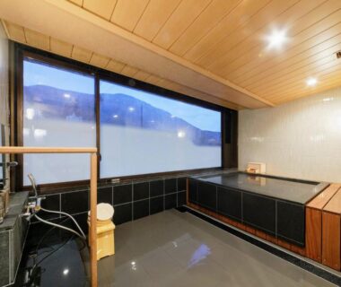 Indoor onsen with wooden ceiling, tiled bath and large window at Hakoneji Kaiun, Kanagawa