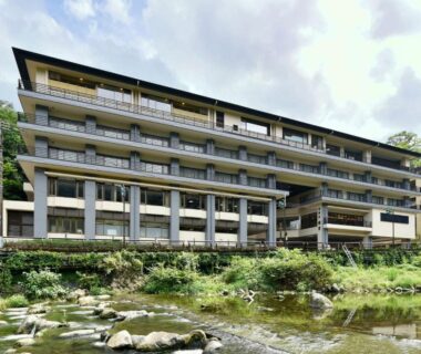 Multi-story ryokan with balconies and riverfront setting in Kanagawa prefecture, Japan