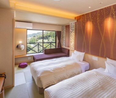 Twin beds and balcony overlooking greenery at Hakonenomori Okada in Kanagawa, Kantō