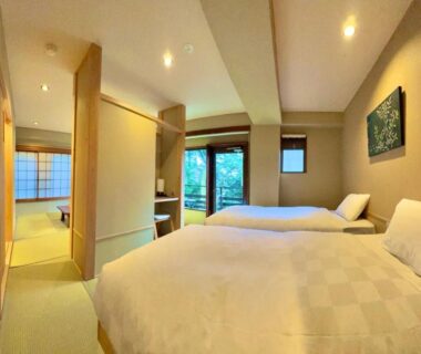 Twin Western beds with adjoining tatami seating area, shoji screens and garden-facing glass door at Hakonesaryo Kintoki Kanagawa