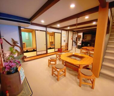 Spacious tatami seating area with low table and stools at Hakuunsou ryokan, Gifu Prefecture, Chūbu region