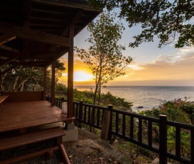 Wooden veranda overlooking the sea at sunset at Hamachidorinoyu Kaisyu in Wakayama