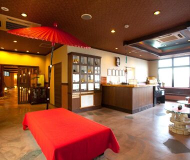 Lobby with red bench and umbrella at Hamazen Ryokan in Kumamoto, Kyushu