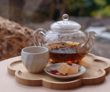 Glass teapot, teacup and sweets on wooden tray at Hana Beppu ryokan in Ōita, Kyūshū