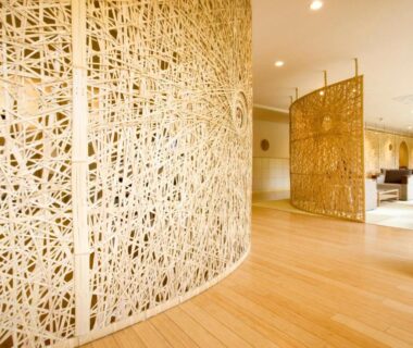 Curved woven room divider and light wood flooring in Hana Beppu reception area, Ōita, Kyūshū