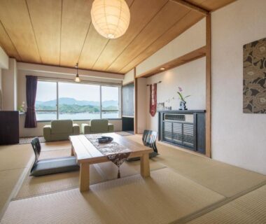 Traditional tatami room with low table and water view at Hana Irodori no Yado Kayuu, Wakayama