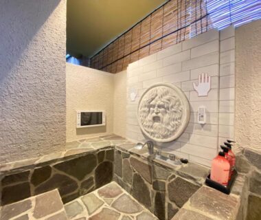 Stone soaking tub with carved wall fountain and faucet, Hana No Shizuku, Saga, Kyūshū, Japan