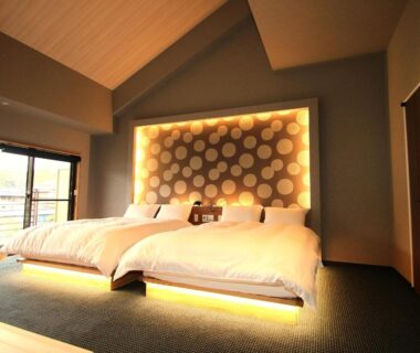 Low-platform twin beds with illuminated headboard at Hana No Shizuku in Saga, Kyūshū