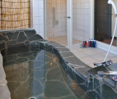 Indoor stone soaking bath with shower area at Hana No Shizuku, Saga, Kyūshū, Japan