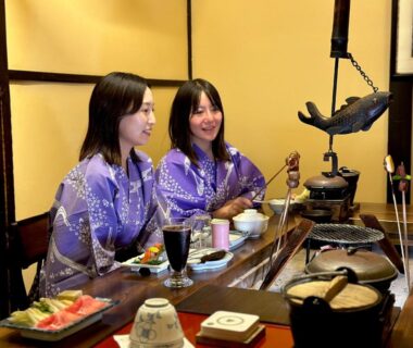 Two women in purple yukata at a low dining table in Hana to Hana, Tochigi ryokan