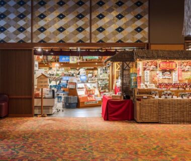 Lobby gift shop with shelves of packaged souvenirs, wicker baskets and warm lighting
