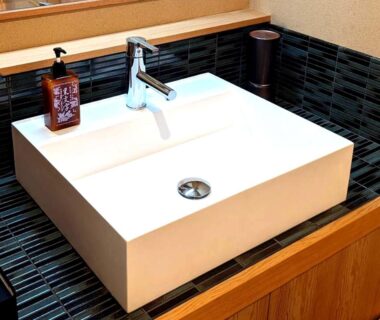 Rectangular white washbasin with chrome faucet on wooden vanity at Hanafubuki ryokan, Shizuoka, Chūbu region