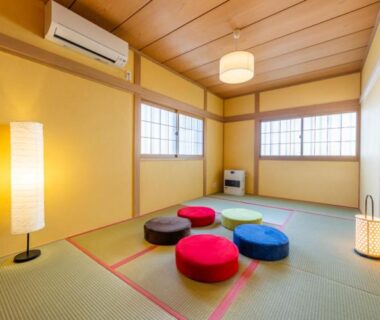 Traditional tatami room with colorful round floor cushions, shoji windows and soft lantern lighting at Hanaingen in Gunma Kantō
