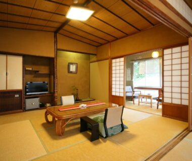 Traditional tatami room with low wooden table, shoji screens and window seating at Hanakanzashi, Fukushima