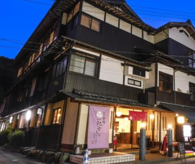 Traditional multi-story ryokan exterior with illuminated entrance, Hanamandara, Hyōgo, Kansai