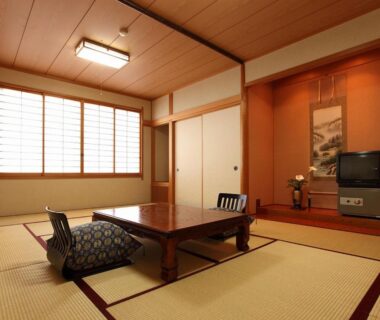 Traditional tatami room with low table, zabuton chairs, shoji window and tokonoma alcove