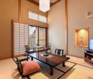 Traditional tatami room with low table, zabuton cushions, shoji screens and tokonoma at Hanare Yado Yosizumi Shizuoka
