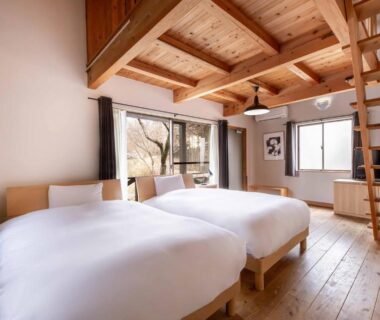 Twin beds in wooden room with loft ladder at Hanare no Yado Hanagokoro, Kumamoto, Kyushu, Japan