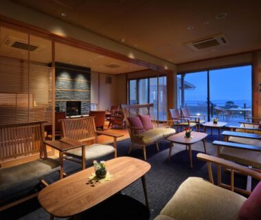 Cozy wooden lounge with low tables and large windows at Hanashibuki, Chiba, Kantō