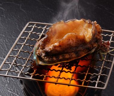 Charcoal-grilled abalone on small grill at Hanashibuki, Chiba ryokan