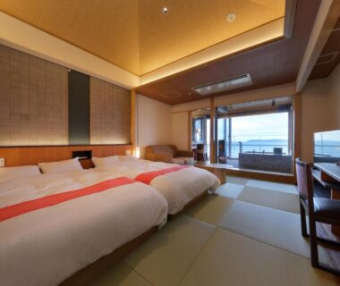 Tatami room with two beds and balcony overlooking the sea at Hanashibuki, Chiba, Kantō
