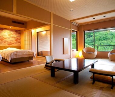 Tatami room with low table, twin beds and lush green view at Hanashinsui in Mie, Kansai