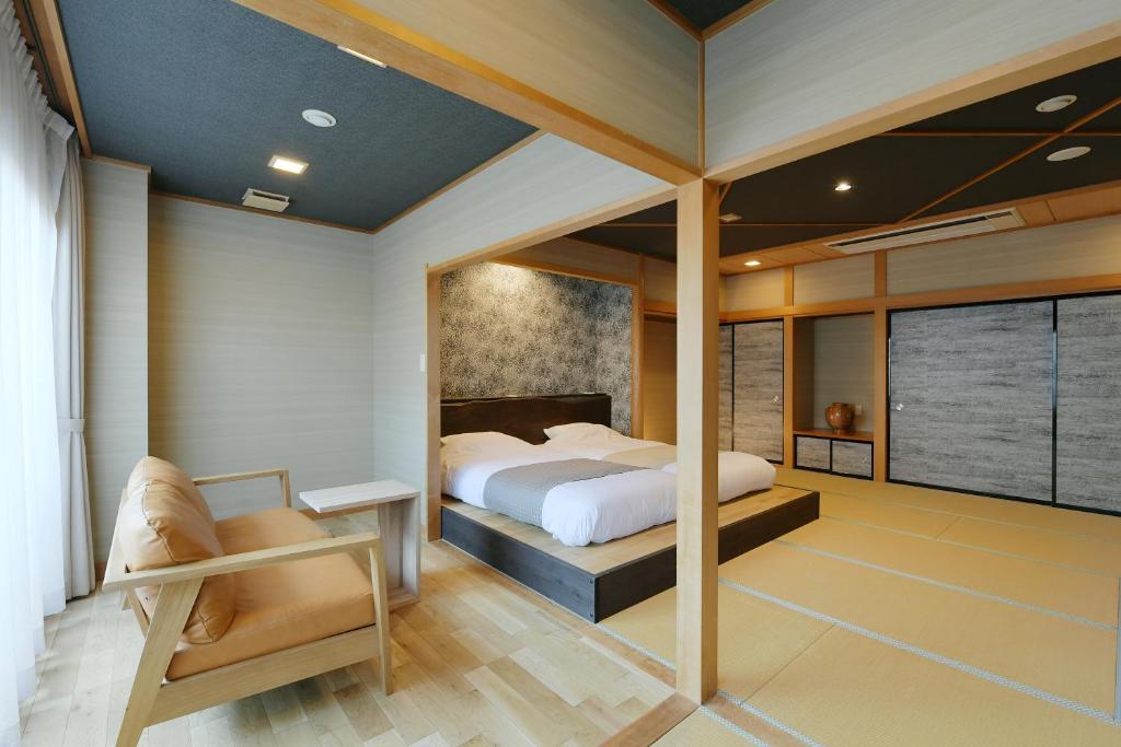 Tatami Room Hanasuishou Chūbu Yamanashi Japan Tatami flooring with raised Western-style beds, seating area and sliding fusuma doors at Hanasuishou, Yamanashi, Chūbu, Japan