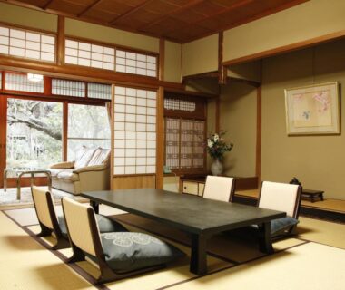 Traditional tatami room with low table, shoji screens and garden view at Hashinoya Bekkan Ransui, Hyōgo