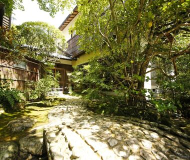 Stone path and moss garden with traditional wooden ryokan architecture at Hashinoya Bekkan Ransui, Hyōgo