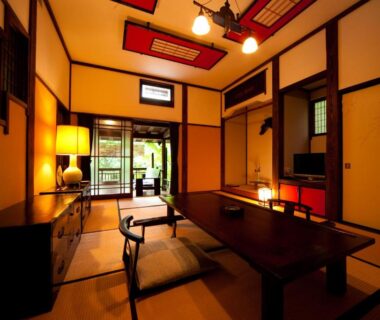 Tatami room with low wooden table, shoji screens and garden view at Hatago Kayausagi in Oita, Kyushu