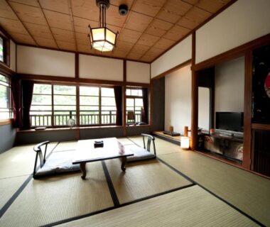 Traditional tatami room with low table, shoji windows and wooden ceiling at Hatago Kayausagi in Ōita, Kyūshū