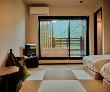 Tatami flooring room with twin beds, balcony and mountain view at Hatago Kintoen in Kanagawa