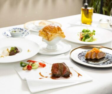 Assorted plated courses on white tablecloth at Hatago Sakura in Ōita