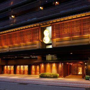 Lit wooden facade and entrance of Hatori ryokan in Ishikawa, Chūbu region