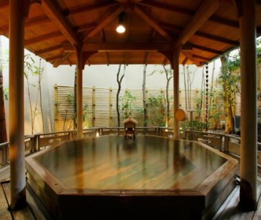 Octagonal wooden onsen bath under a timber pavilion at Hatori in Chūbu, Ishikawa, Japan