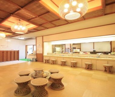 Spacious tatami style lobby with low stools and wooden counters at Hatoya Hotel in Shizuoka, Chūbu Japan