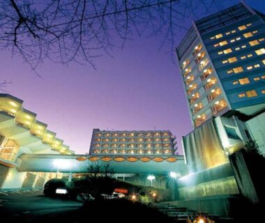 Illuminated exterior and main entrance of Hatoya Hotel at dusk in Shizuoka, Chūbu region