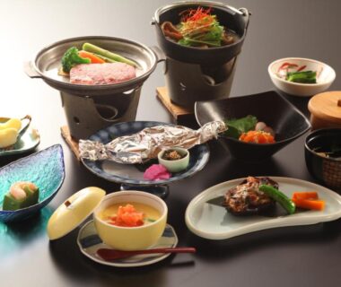 Assorted multi-course Japanese dishes on lacquerware and small pots at Hatsunoyu ryokan, Nagano, Chūbu, Japan