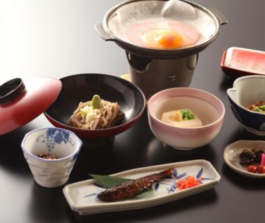 Assorted small dishes with grilled fish and simmering pot served at Hatsunoyu ryokan in Nagano