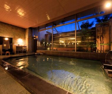 Indoor onsen bath at dusk with large windows, Hayamakan, Yamagata, Tōhoku, Japan