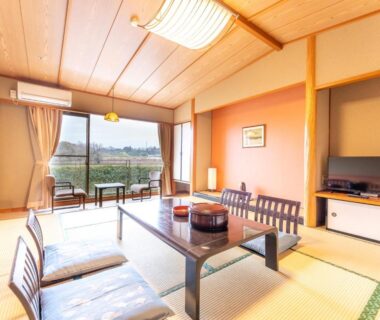 Tatami room with low table and cushions at Healthy Pal Akagi in Gunma overlooking fields