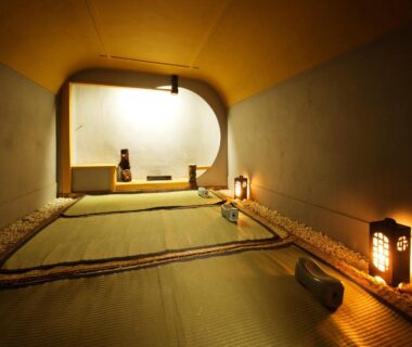 Tatami room with alcove, soft lanterns and cushions at Heihachi Tea House Inn Kyoto
