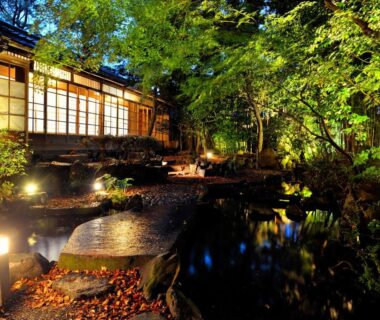 Night garden with pond, stone lanterns and shoji facade at Heihachi Tea House Inn Kyoto